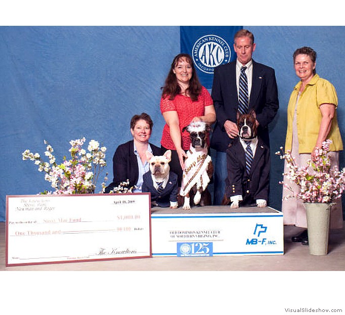 Newman and Roger (left) present a
                                $1000 check to the AABR for the Sassy
                                Mae (center) fund.